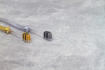 Two silver and gold toothbrushes for brushing teeth with antibacterial coating