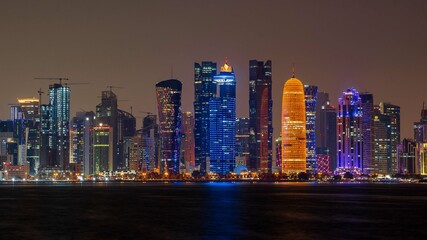 view of doha corniche during night along with fanar building.