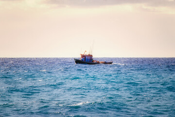 a small fishing boat in the open water on the atlantic ocean