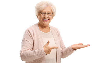 Smiling elderly woman pointing at her hand