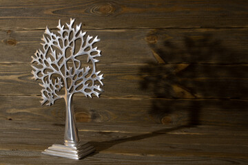 decorative silver tree on the background of wooden boards