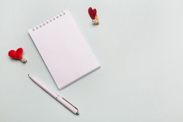 Top view of open spiral blank notebook with pen on desk background. Isolated on mint color backdrop.