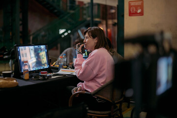 Director at work on the set. The director works with a group or with a playback while filming a movie, advertising