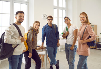 Group of happy diverse fellow students. Indoor portrait of five positive mixed race multiethnic...