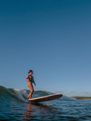 Girl Surfing on her longboard