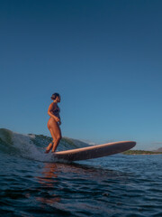 Girl Surfing on her longboard