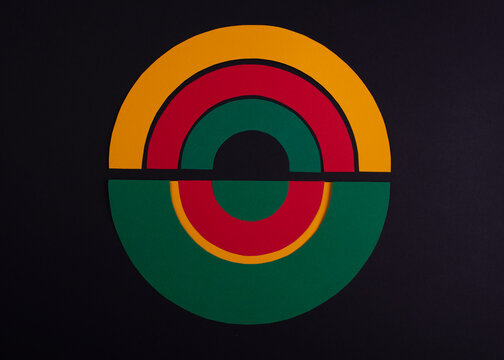 Black history month colors rainbows circle. Paper cut abstract composition on dark background.