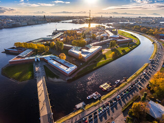 Russia, St. Petersburg, Aerial landscape of Peter and Paul cathedral at sunset, walls of fortress, Golden autumn, panorama landscape, golden spire with cross and angel, drawbridges, river Neva