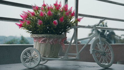 Fototapeta na wymiar flowers in a miniature bicycle