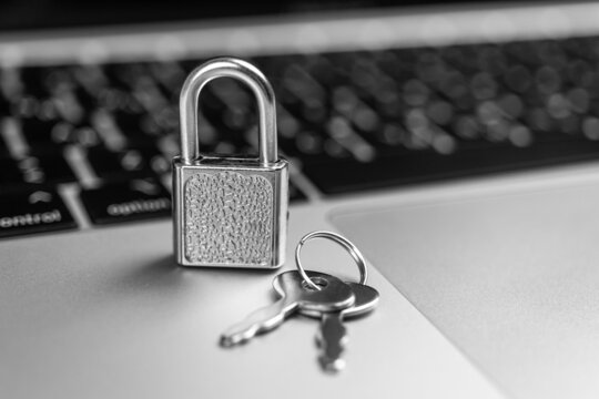 Computer security concept. Padlock on computer keyboard, laptop in office. Cyber security and privacy background photo