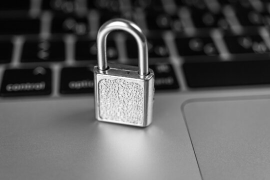 Computer security concept. Padlock on computer keyboard, laptop in office. Cyber security and privacy background photo