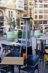 Image of a gas stove for the terrace of a bar that has tables on the street in winter