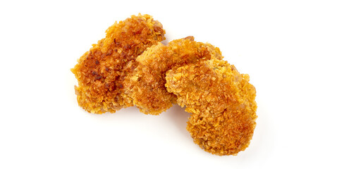 Fried Tasty Crispy Breaded Chicken Nuggets with basil leaves and spicy sauce, close-up, isolated on a white background.