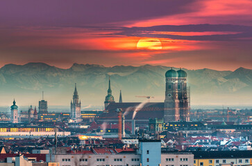 Munich skyline aerial view, munich germany at sunset view of frauenkirchr in marienplatz old town view cathedral in background pre alps mountains winter snow. - obrazy, fototapety, plakaty