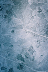 Broken and refrozen ice covers a walkway creating an abstrct pattern