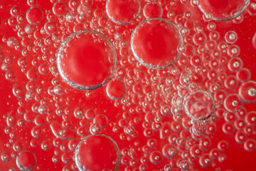 A lot of bubbles in a red liquid close-up.