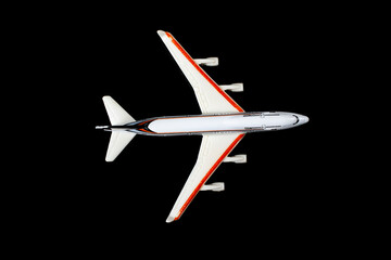 Fototapeta na wymiar Passenger plane model isolated on black background.