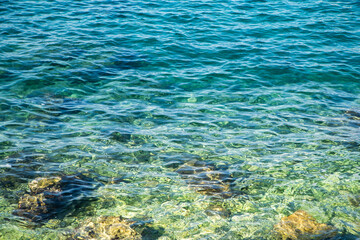 Fototapeta na wymiar blue sea water background. clear sea water visible seabed.
