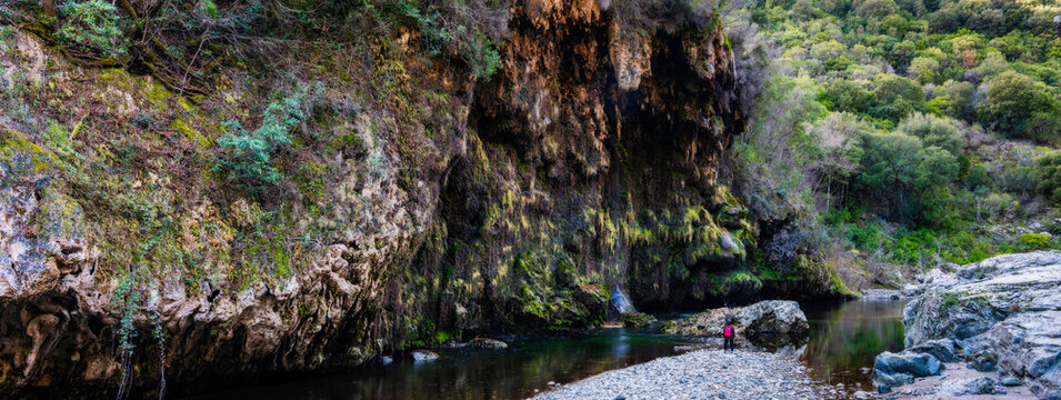 Observer in front of the Sa Stiddiosa Waterfall, immersed in the narrow Flumendosa valley, in the Gennargentu National Park, Seulo, Cagliari - Sardinia