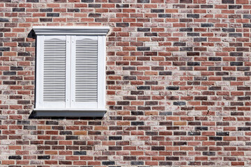 Red brick and white shuttered rectangle window