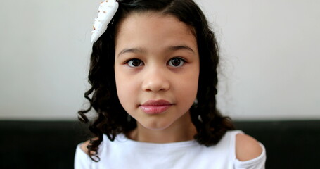 Ethnically diverse little child girl looking at camera portrait