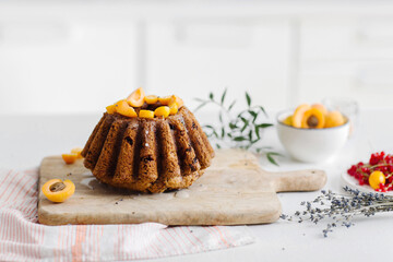 Fruitcake and raisins on a kitchen table. Homemade cupcake with fresh berries on a white table. High quality photo