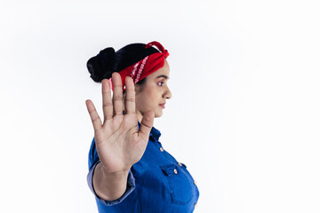 Hispanic woman raising her hand in stop concept, on white background.