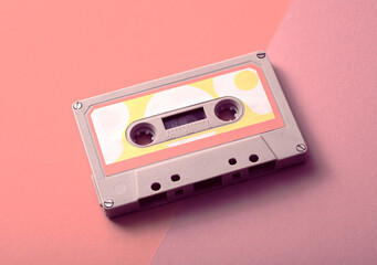 Old Vintage Audio Cassette, Compact Cassette, or Musicassette on a Seamless Trending Colorful Background. Conceptual Photo about eighties music