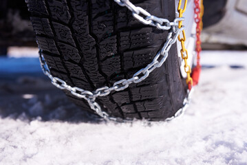 snow chain on a wheel in deep snow in winter