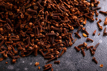 Aromatic spice cloves herbs on rustic table