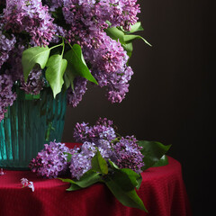 Bouquet of purple lilac in a glass vase.