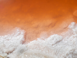 Orange water and white salt close-up, Giraud salt pans, France