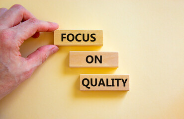 Focus on quality symbol. Concept words Focus on quality on blocks on beautiful white table white...