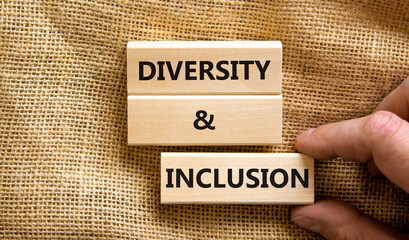 D and I, Diversity and inclusion symbol. Concept words D and I, diversity and inclusion on blocks on beautiful canvas table canvas background. Business, D and I, diversity and inclusion concept.