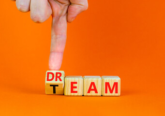 Dream team dreamteam symbol. Businessman turns wooden cubes and changes the word Dream to Team....