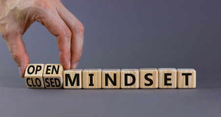 Open or closed mindset symbol. Businessman turns wooden cubes and changes concept words closed mindset to open mindset. Beautiful grey background, copy space. Business open or closed mindset concept.
