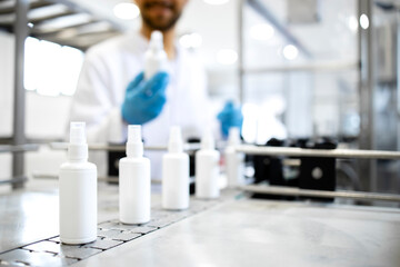 Industrial production of sprat bottle hand sanitizer or disinfectant.  - obrazy, fototapety, plakaty