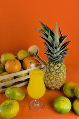 tropical fruits to prepare a natural juice. glass of juice with fruits