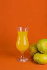 tropical fruits to prepare a natural juice. glass of juice with fruits