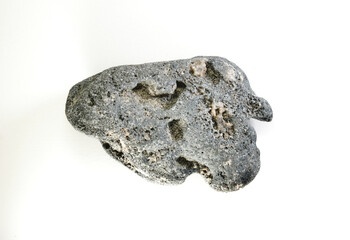 A small meteorite stone in the holes. White background.