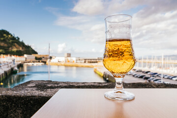 Close-up of a glass of beer on a table with the port in the background