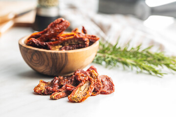 Sun dried tomatoes on white table.