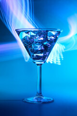 Martini cocktail drink in neon iridescent pink and blue colors.