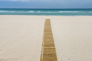 Fototapeta na wymiar Wooden path in Victoria Beach, Cadiz, Spain.