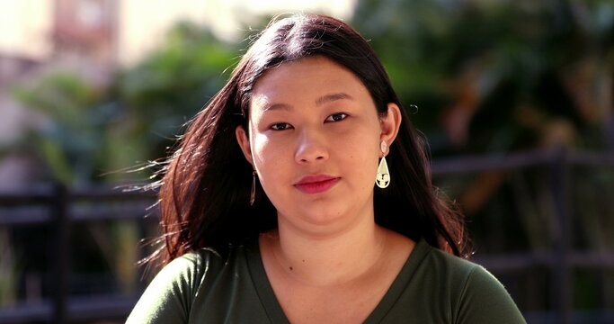 Asian woman portrait looking at camera outside, young Japanese descent ethnically diverse face