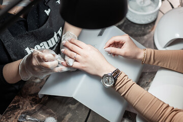 Woman make a manicure in a beauty salon, close-up. Nail care