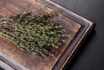 Bundle of fresh thyme grass on a wooden cutting board