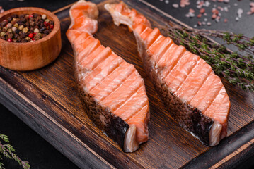 Grilled salmon with herbs served on black concrete table