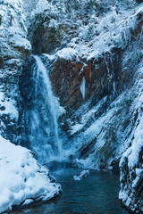 Beautiful waterfall in snowy mountains. Black and white photo. Zhenetsʹkyy Huk. - obrazy, fototapety, plakaty