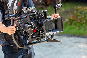 Movie shooting or video production and film crew team with camera equipment. Video camera operator...